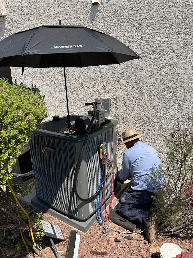 HVAC technician performing outdoor AC maintenance in Jupiter